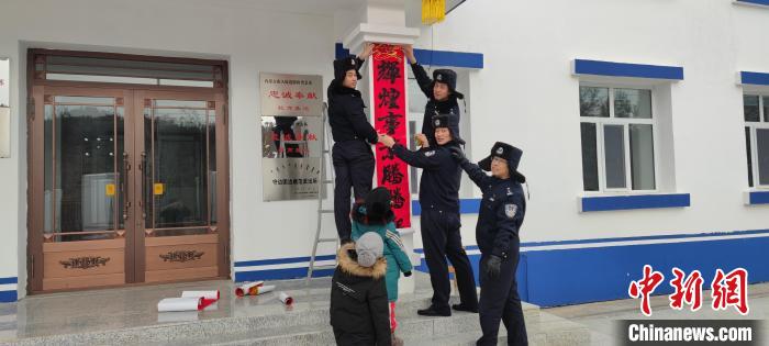 圖為恩和哈達(dá)邊境派出所民警貼對聯(lián)?！《骱凸_(dá)邊境派出所供圖